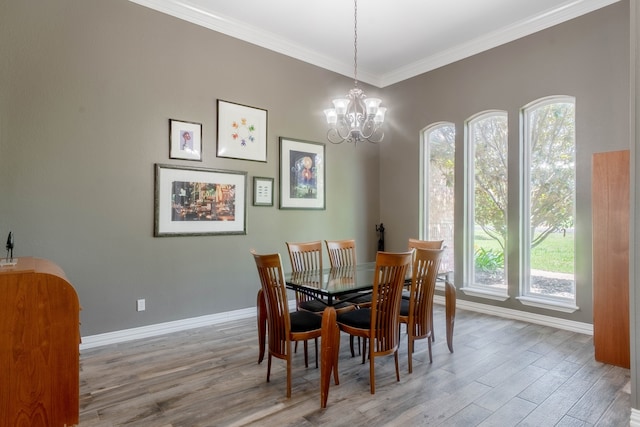 dining space with an inviting chandelier, crown molding, and dark wood-type flooring