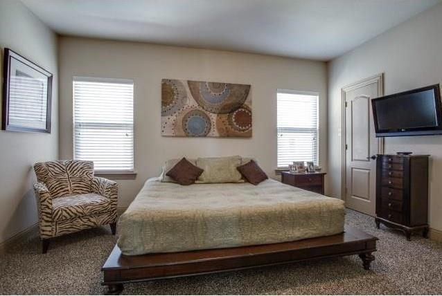 bedroom with carpet flooring and multiple windows