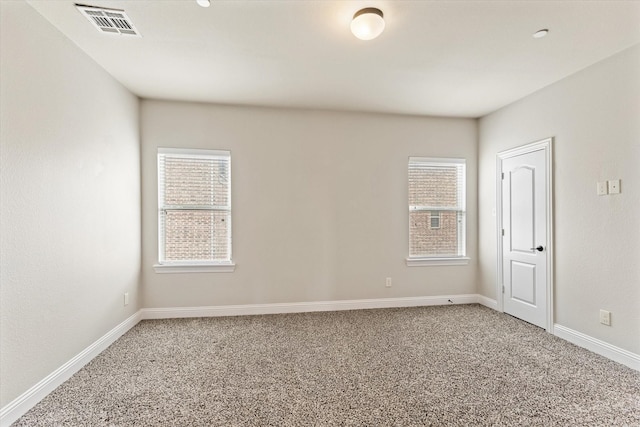 spare room featuring carpet and plenty of natural light