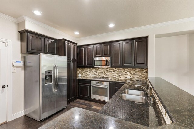 kitchen featuring sink, ornamental molding, appliances with stainless steel finishes, decorative backsplash, and dark hardwood / wood-style floors