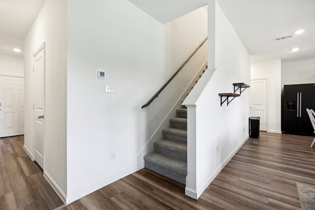 staircase featuring wood-type flooring