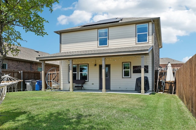 rear view of house featuring a lawn