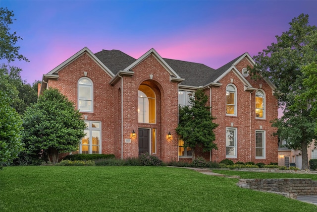 view of front of property with a lawn