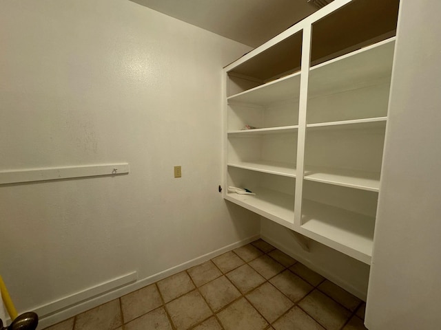 walk in closet with tile patterned flooring