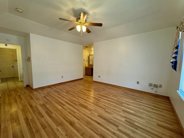 spare room featuring light hardwood / wood-style floors and ceiling fan