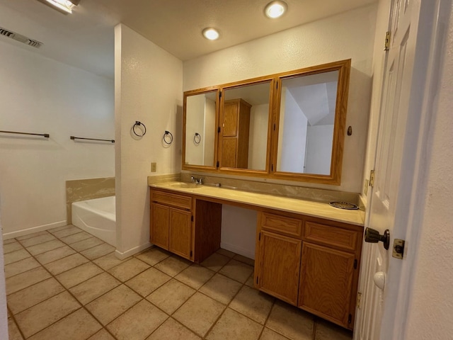 bathroom with tile patterned flooring, recessed lighting, vanity, baseboards, and a bath