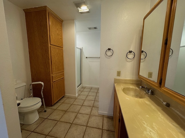 bathroom with toilet, an enclosed shower, tile patterned flooring, and vanity