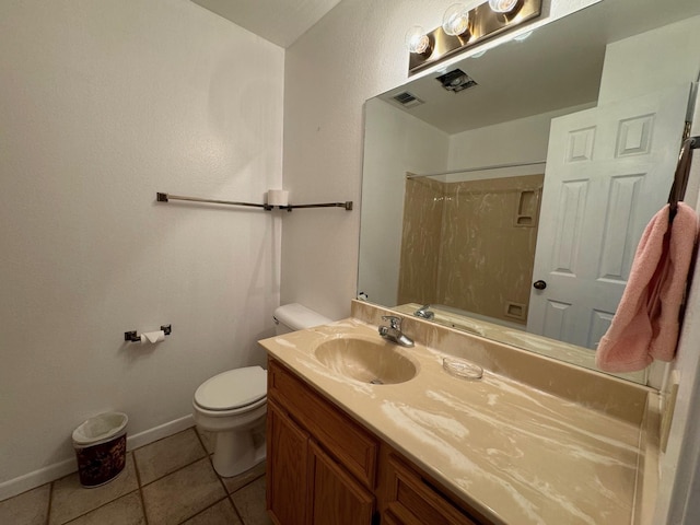 full bathroom featuring tile patterned flooring, toilet, vanity, baseboards, and walk in shower