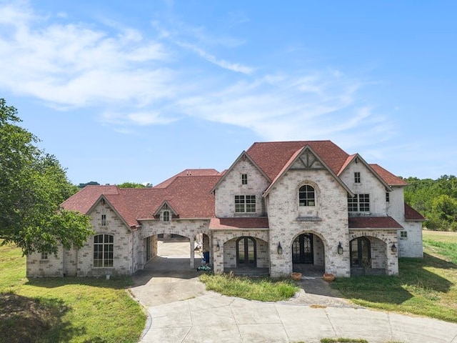 french provincial home featuring a front yard