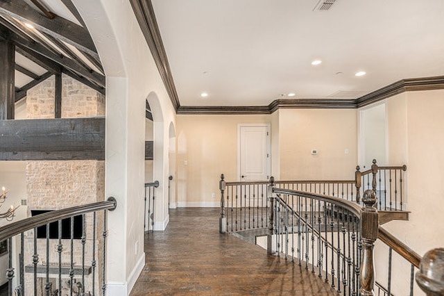 hall featuring ornamental molding and dark hardwood / wood-style flooring