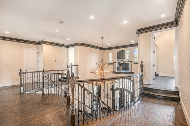 hallway with dark wood-type flooring and crown molding