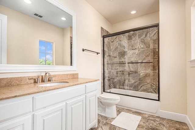 full bathroom with vanity, toilet, and bath / shower combo with glass door