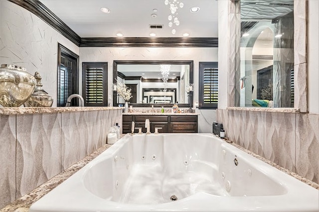 bathroom featuring a tub to relax in, crown molding, and vanity