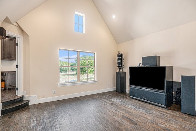 living room with hardwood / wood-style floors and high vaulted ceiling