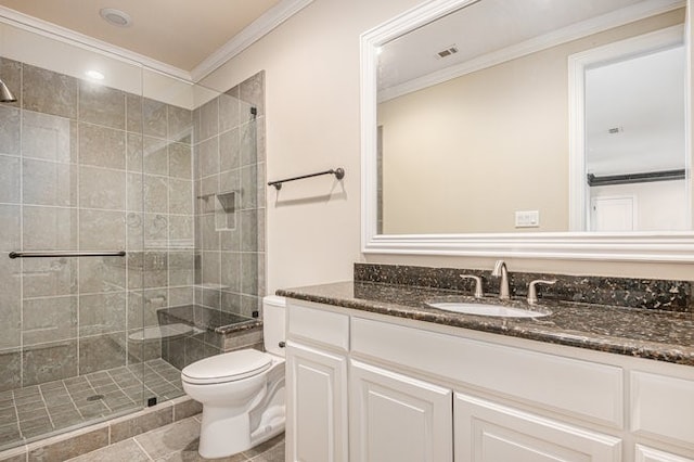 bathroom featuring tile patterned flooring, toilet, a tile shower, vanity, and ornamental molding