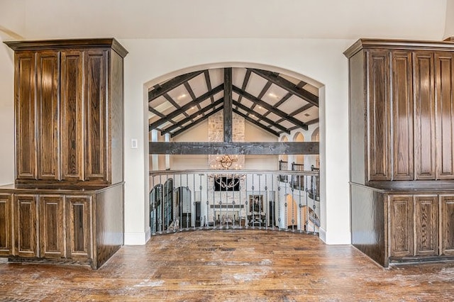 interior space featuring high vaulted ceiling, wood-type flooring, and beam ceiling