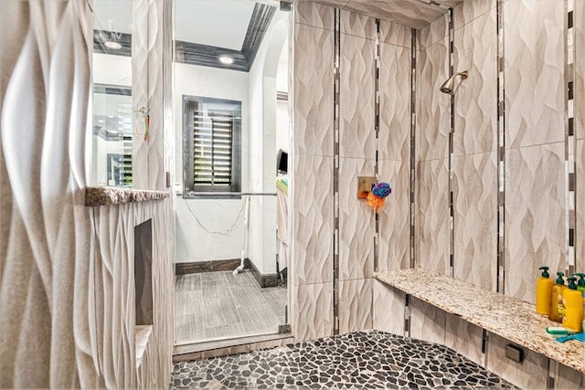 bathroom featuring walk in shower and ornamental molding