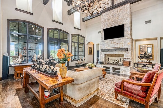 living room with a high ceiling, a fireplace, and dark hardwood / wood-style floors