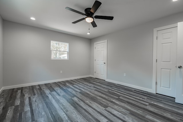 spare room with ceiling fan and dark wood-type flooring