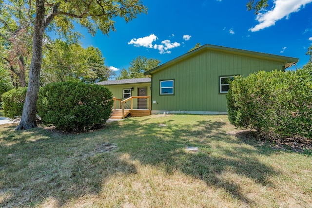 rear view of property with a lawn