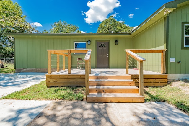 view of exterior entry with a deck