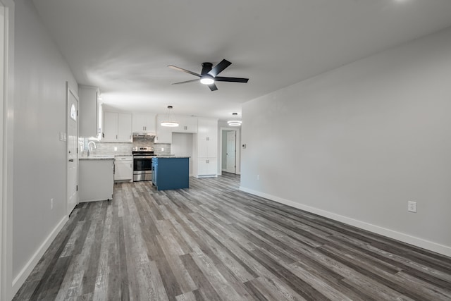 unfurnished living room with ceiling fan, sink, and wood-type flooring