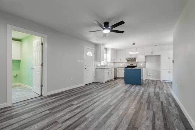 unfurnished living room with ceiling fan, hardwood / wood-style flooring, and sink