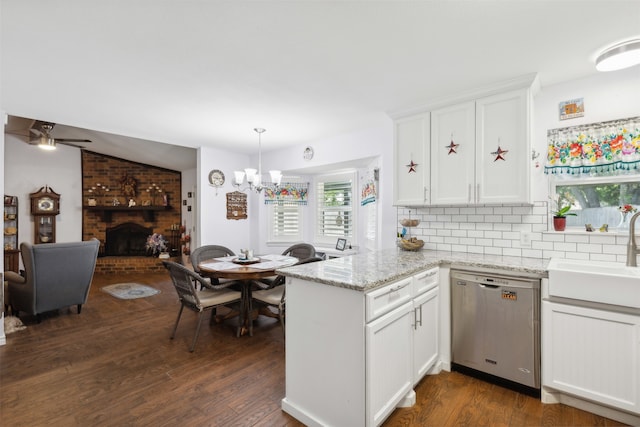 kitchen featuring dishwasher, white cabinetry, dark hardwood / wood-style floors, lofted ceiling, and ceiling fan with notable chandelier