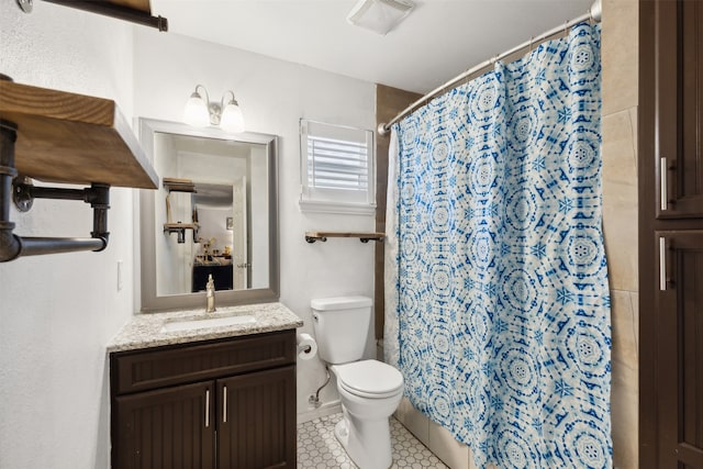 bathroom with tile patterned floors, vanity, and toilet