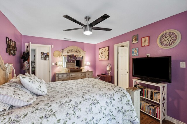 bedroom featuring ceiling fan and dark hardwood / wood-style floors