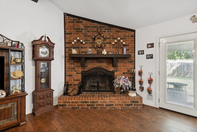 living room with a fireplace, dark hardwood / wood-style floors, and lofted ceiling