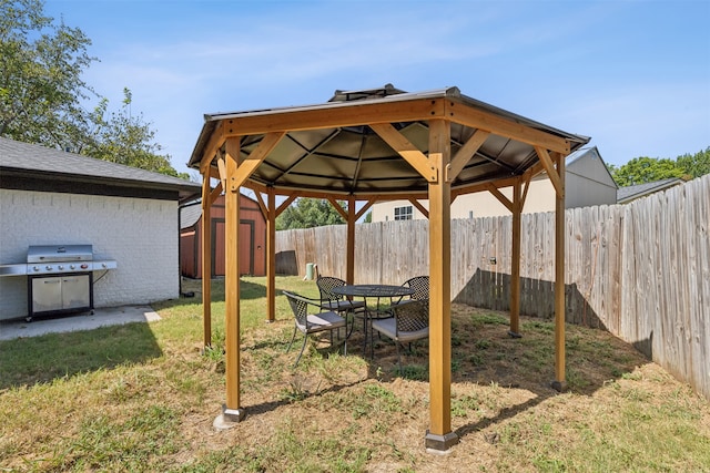 view of yard with a gazebo and a storage shed