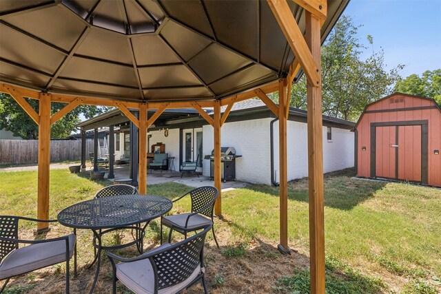 view of patio / terrace featuring a gazebo, a grill, and a storage unit