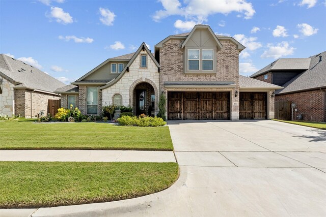 view of front of home with a garage and a front yard