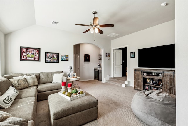 carpeted living room featuring vaulted ceiling and ceiling fan