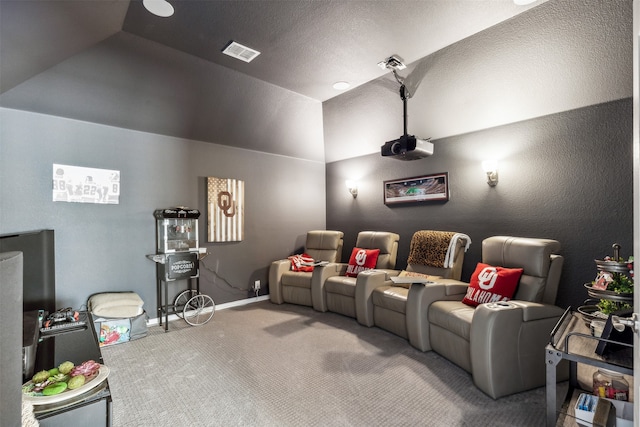 cinema featuring lofted ceiling and carpet flooring