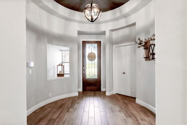 entryway featuring a chandelier and light hardwood / wood-style flooring