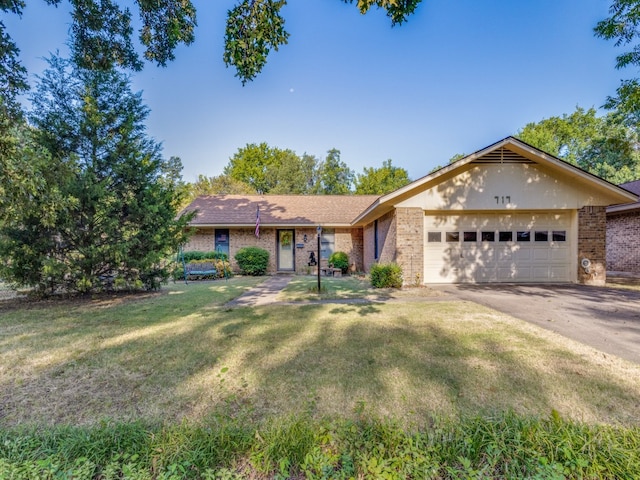 ranch-style house with a garage and a front yard