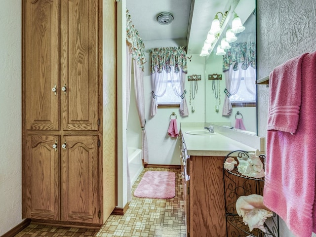 bathroom featuring shower with separate bathtub, vanity, and tile patterned floors