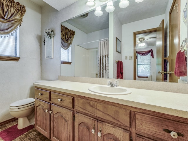 bathroom with a textured ceiling, tile patterned flooring, vanity, curtained shower, and toilet