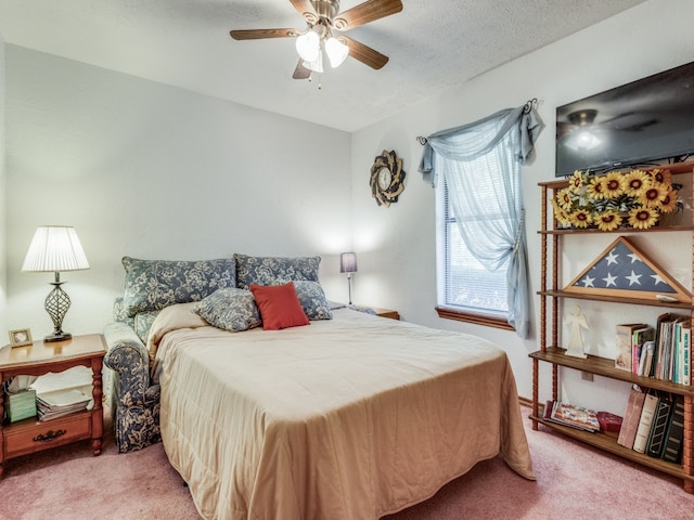 bedroom with a textured ceiling, carpet floors, and ceiling fan