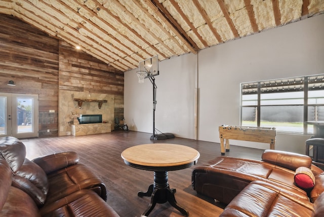 living room featuring plenty of natural light, high vaulted ceiling, hardwood / wood-style flooring, and french doors