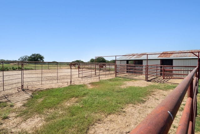 view of yard with a rural view and an outdoor structure