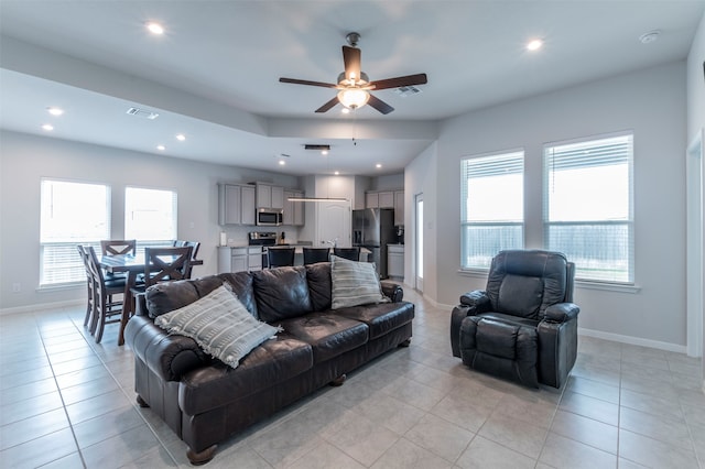 living room with light tile patterned floors and ceiling fan