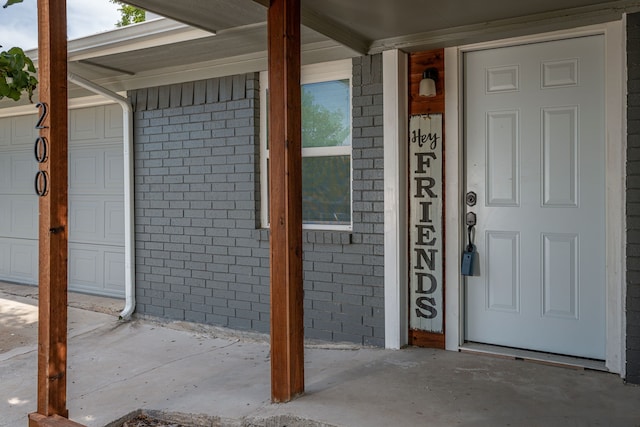 view of exterior entry featuring a porch