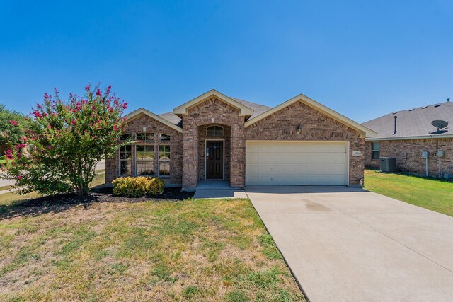 ranch-style home featuring a front lawn, central AC, and a garage