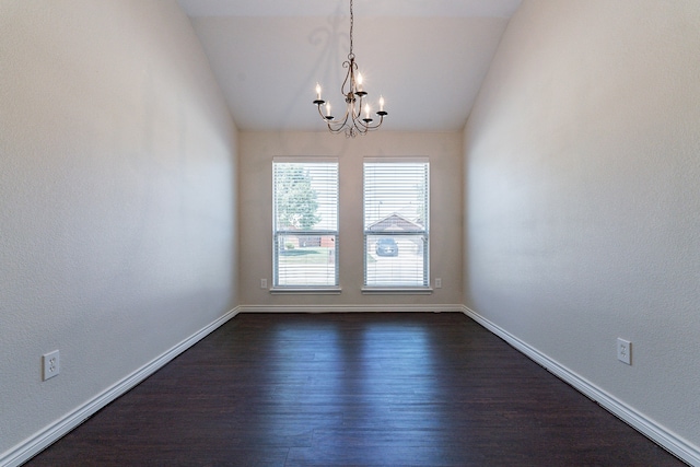 unfurnished room featuring dark wood-type flooring, a chandelier, and lofted ceiling