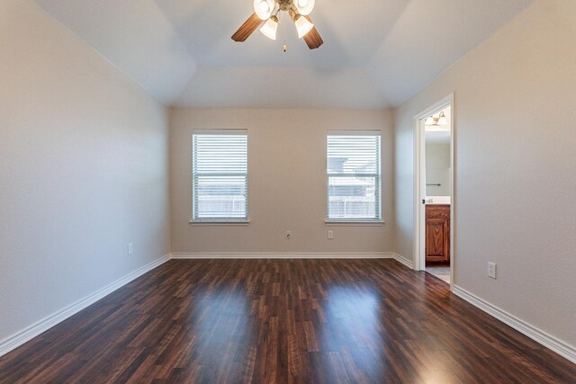 empty room featuring hardwood / wood-style floors, vaulted ceiling, and ceiling fan