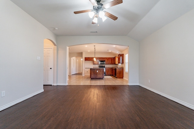 unfurnished living room featuring ceiling fan, lofted ceiling, and light tile patterned floors