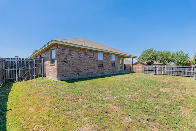 back of house with a yard